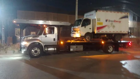 Grúa International remolcando un camión de carga de noche en CDMX